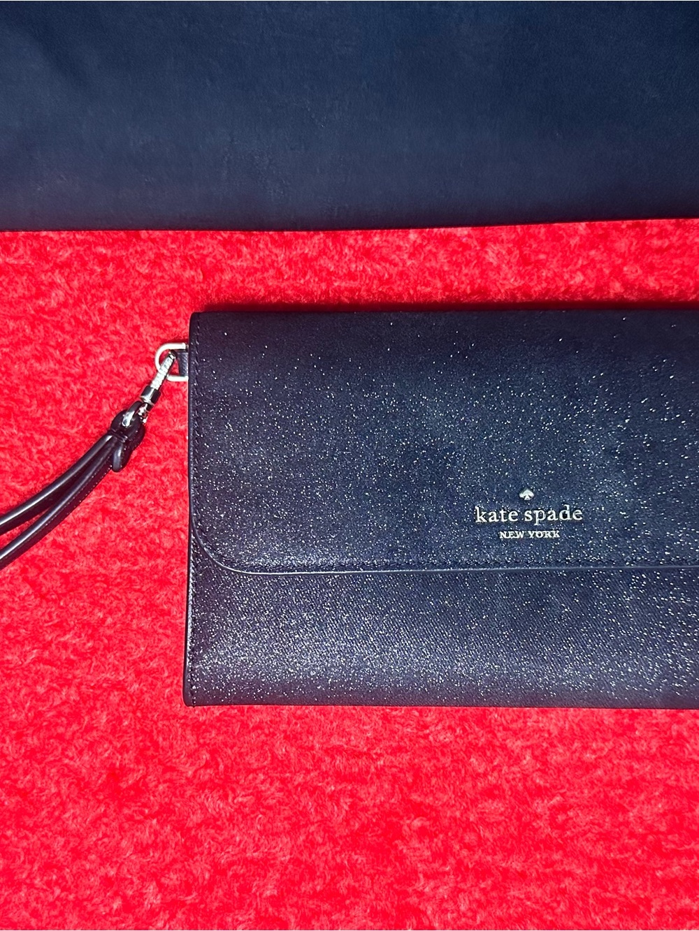 kate spade black glitter wristlet clutch with gold logo